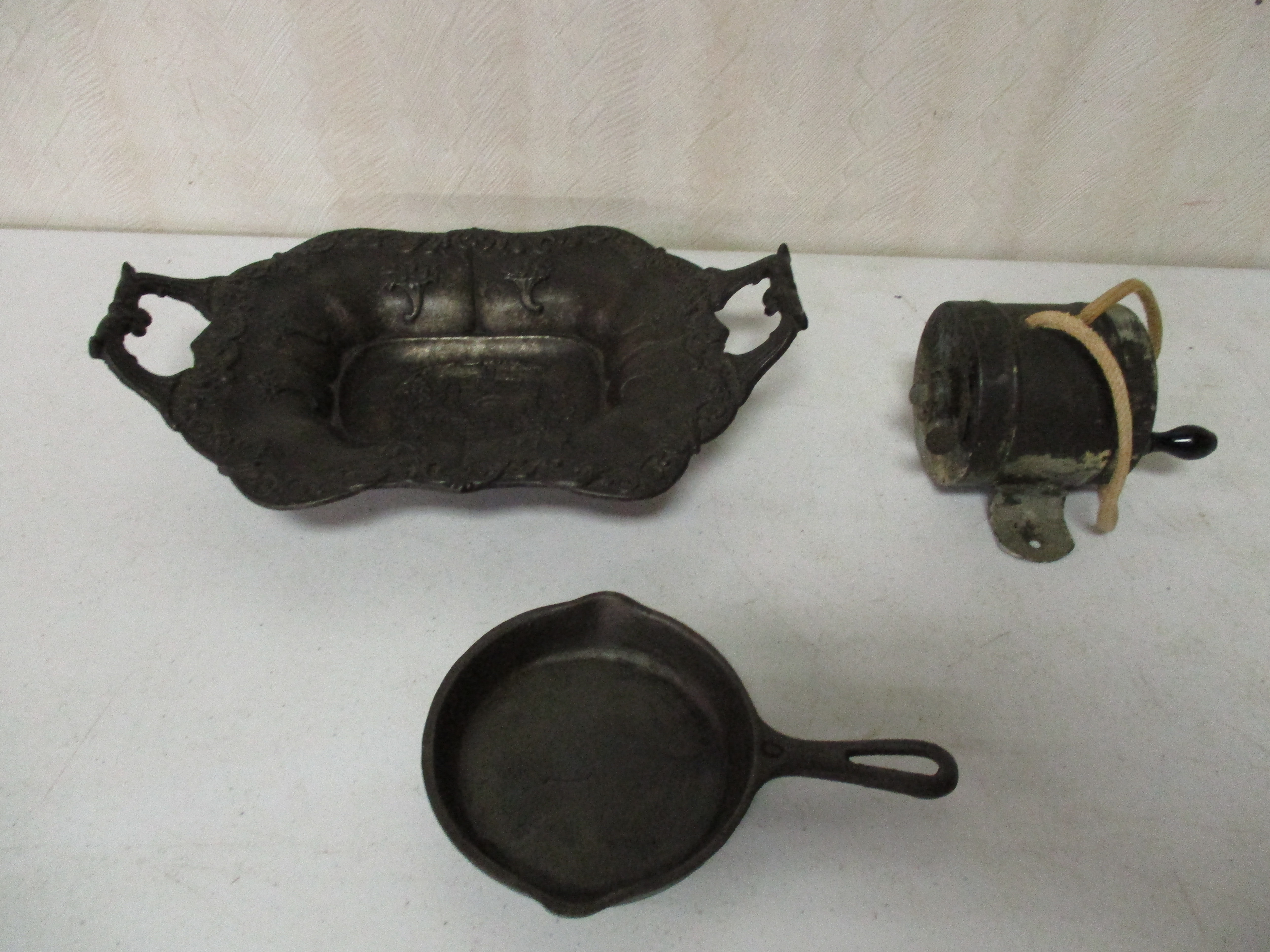 Lot 136: Cast Iron Dish, "0" Griswold Skillet And Old Wash Line Reel