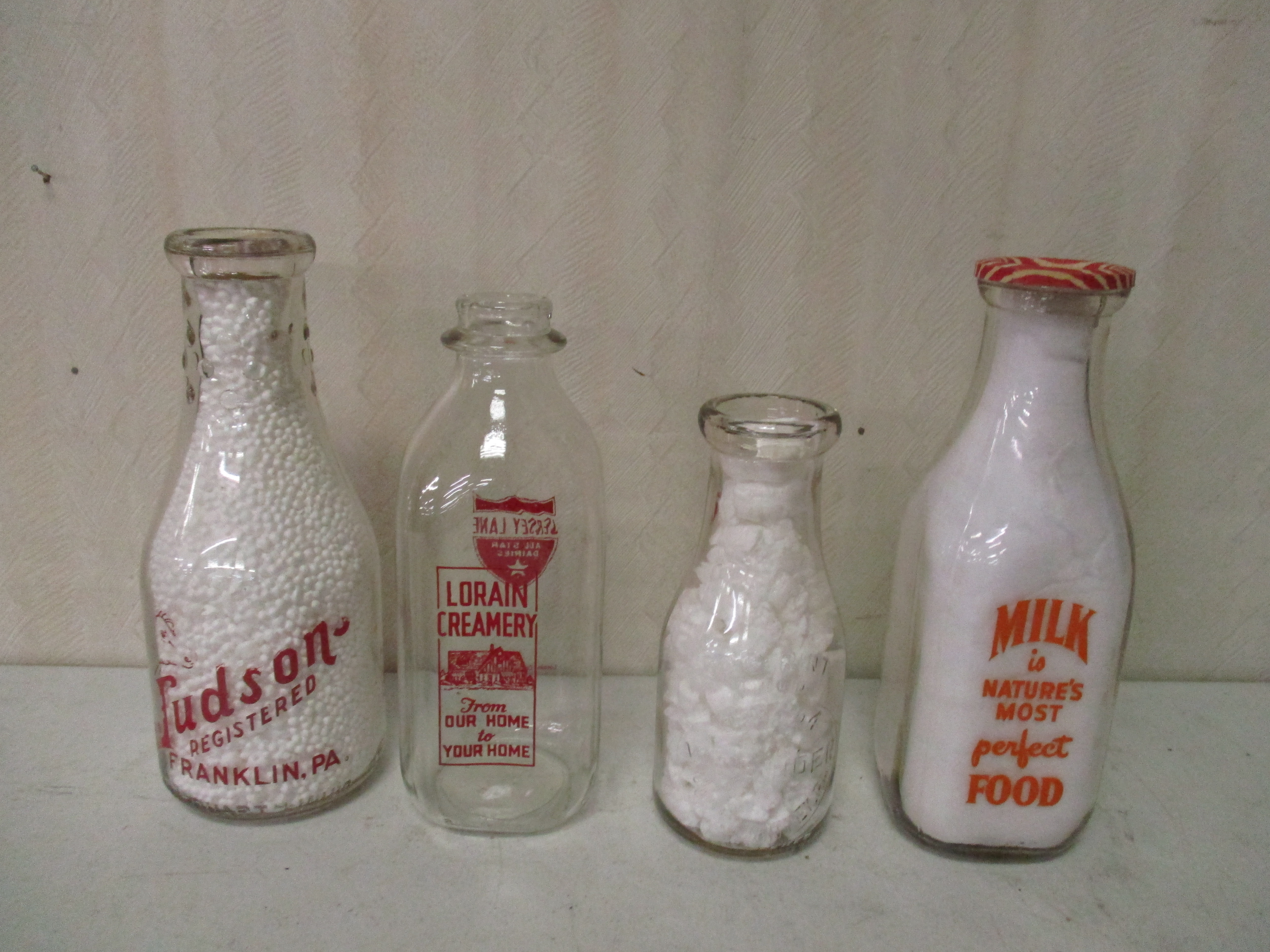 Lot 189: (4) Milk Bottles - Judson (Franklin), Lorain Creamery, MA Vasbinder (pxy) And Yingling's (Titusville)